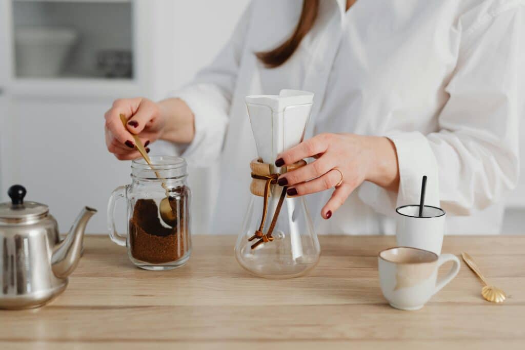 Woman making coffee using Chemex.